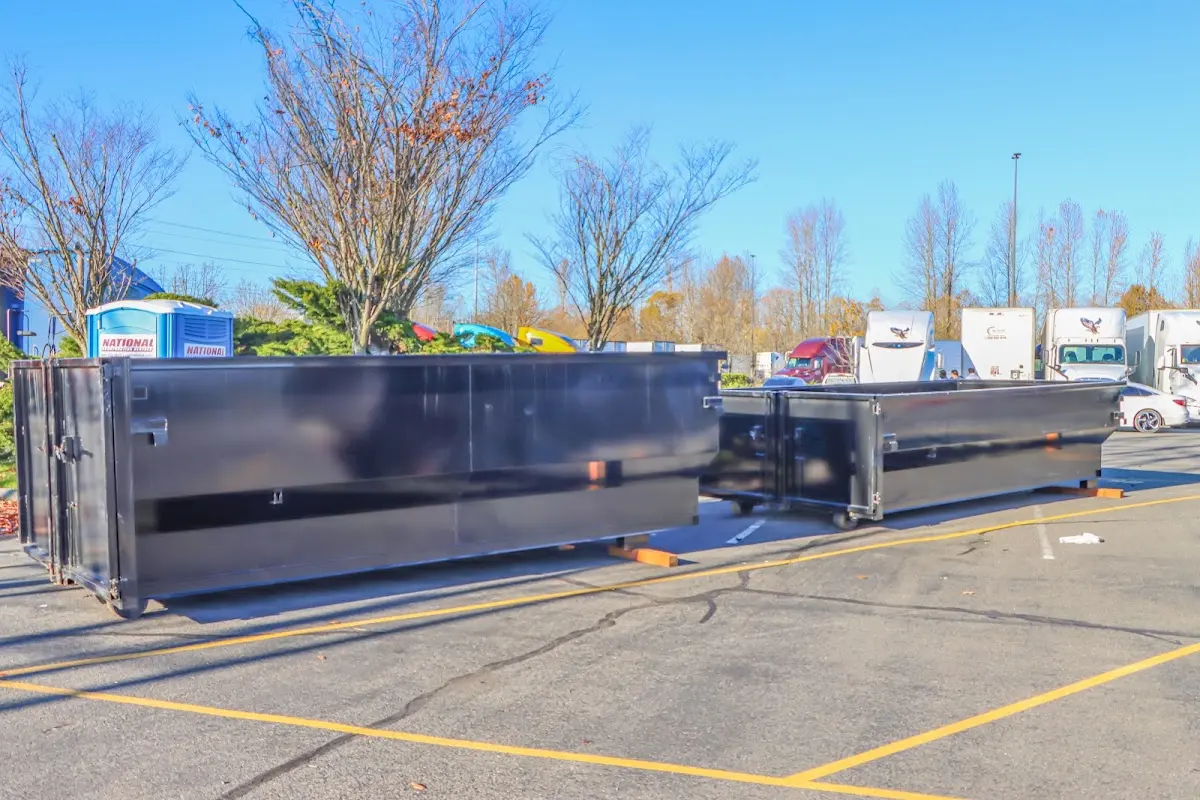 Professional dumpster rental service with roll-off container on residential driveway in Lititz